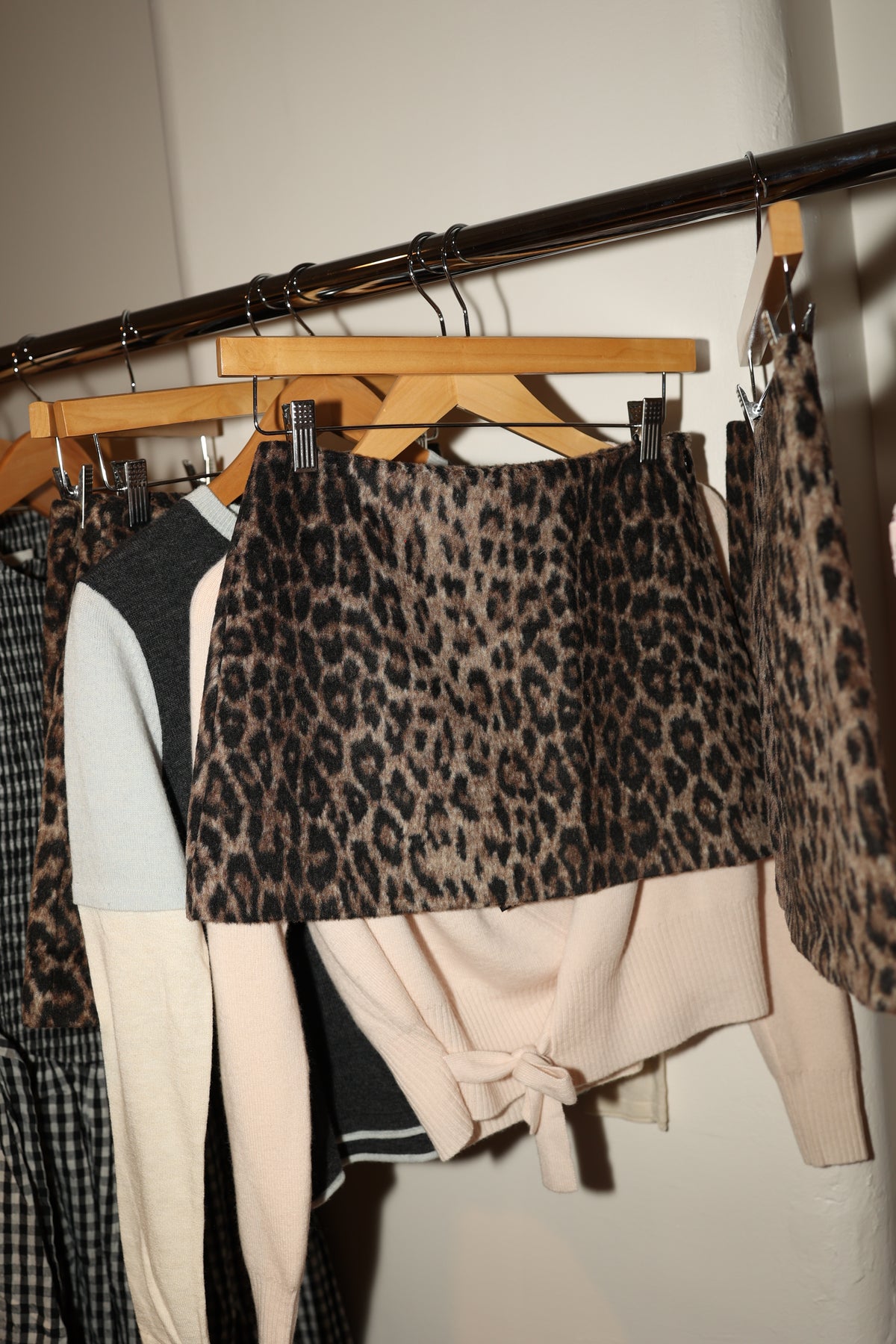Sister NY leopard skort and knitwear on a clothing rack